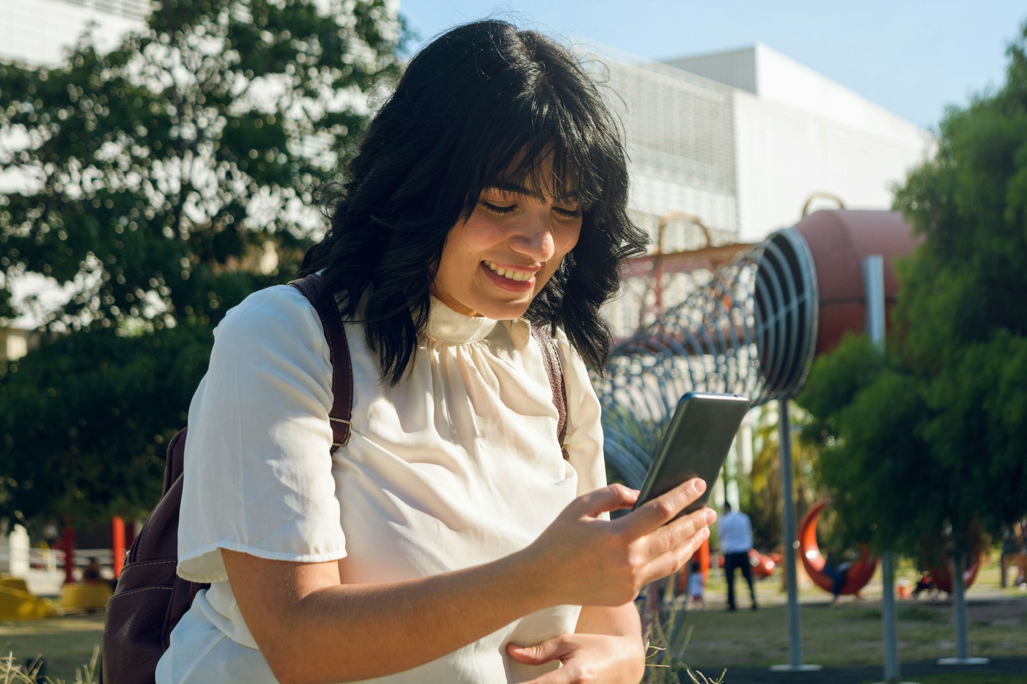 happy young Venezuelan immigrant medical student in Argentina using the phone