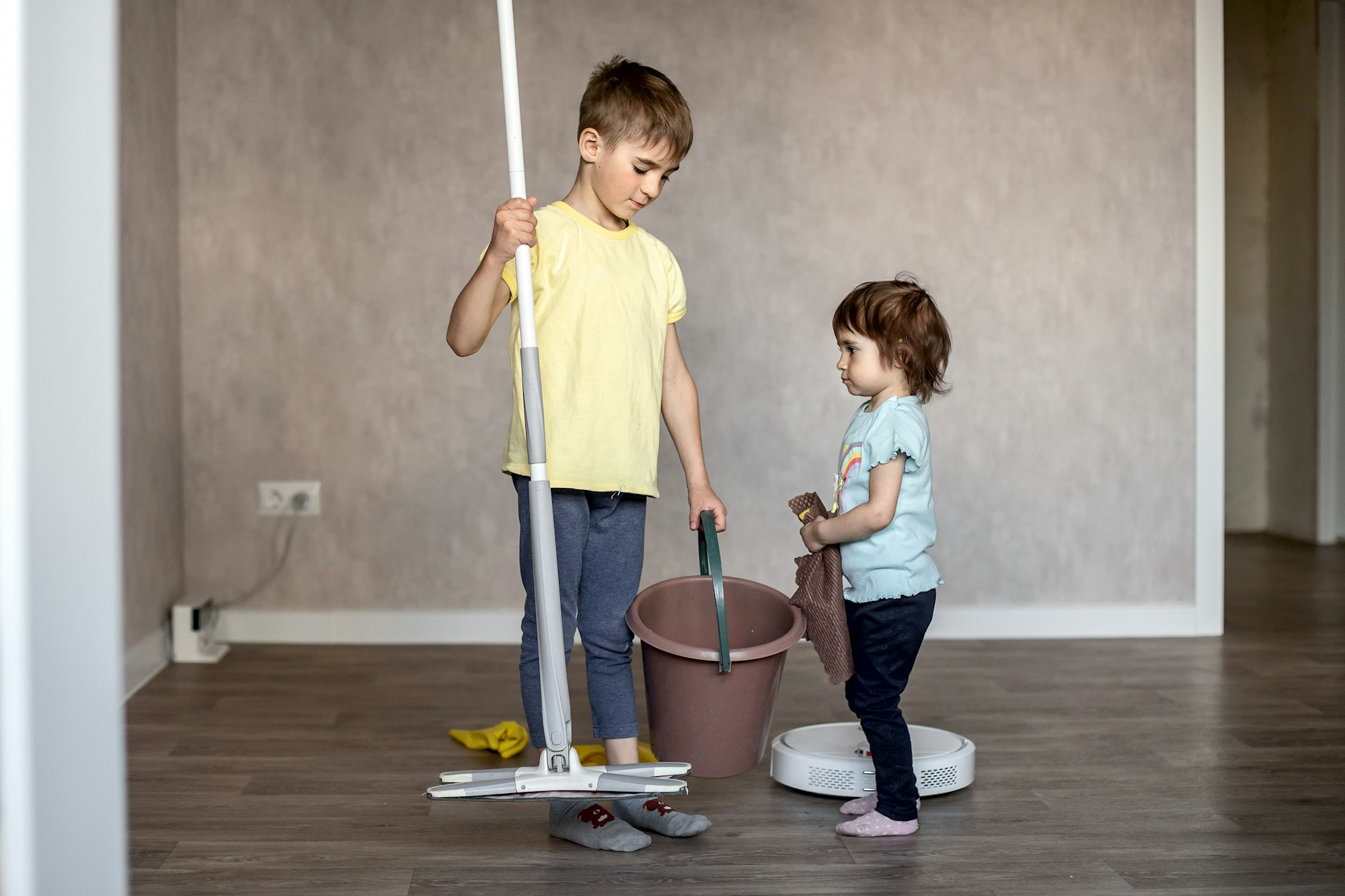 House cleaning, help, housework. The children help their mother clean up.