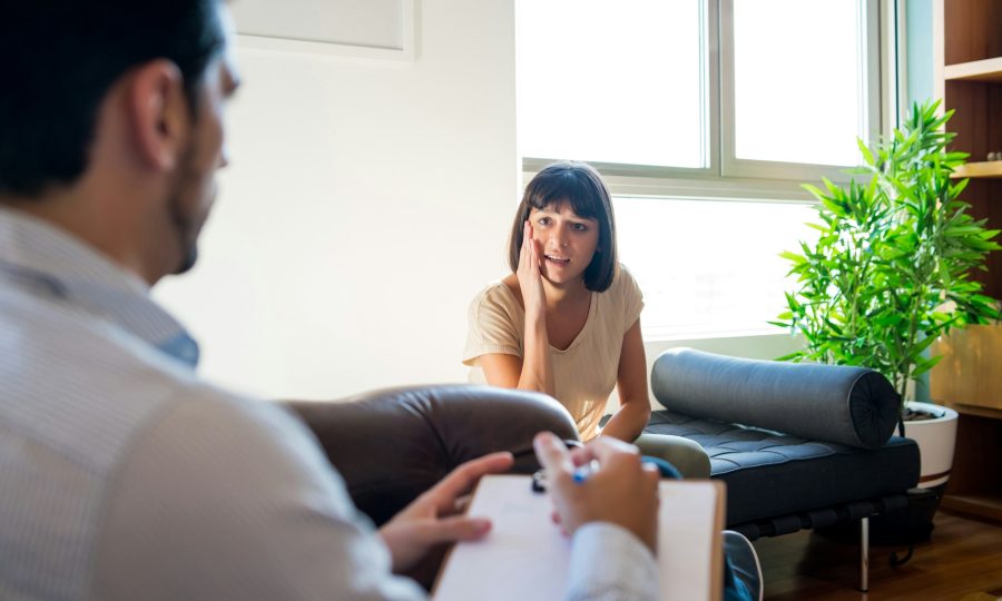 Psychologist talking with patient on therapy session.